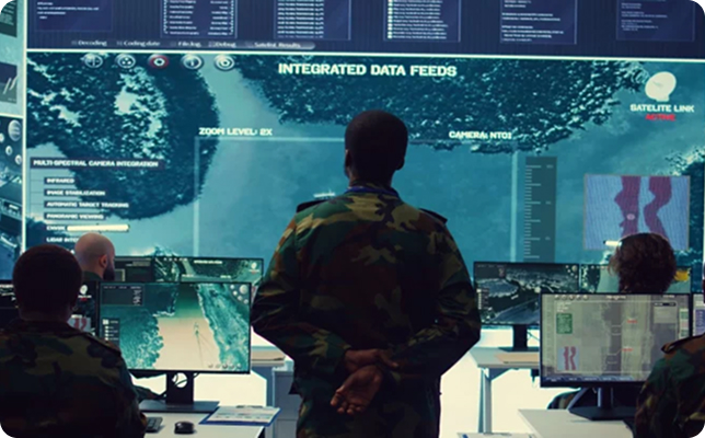 Military personnel monitoring integrated satellite and surveillance data feeds